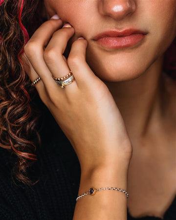 Close-up of permanent jewelry bracelets on wrist