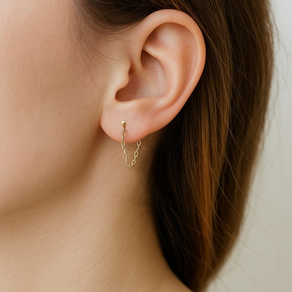 Assortment of everyday wear earrings including hoops, studs, pearls, and bars displayed against a white background