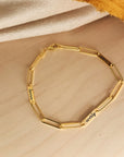 14K solid gold engravable bracelet styled with cream and mustard fabric for a cozy look