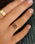 14K solid gold fingerprint band worn on hand with green sweater