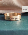 14K solid gold handwriting ring worn with necklace, woman’s hand resting near heart