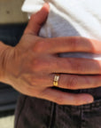 14k solid gold handwriting ring on model's hand resting on hip