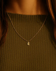 14K solid gold initial pendant necklace styled with dark green textured top