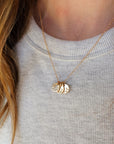 Close-up of woman wearing 14K solid gold name necklace with three personalized tags