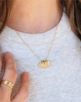 Woman wearing 14K solid gold name necklace with rings and personalized tags