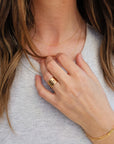 Model showcasing 14K solid gold personalized band with hand placed over chest