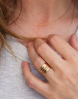 Model wearing 14K solid gold personalized band with engraved names on wide gold ring