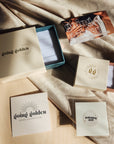 14K solid gold personalized necklace shown with Going Golden gift packaging and velvet box