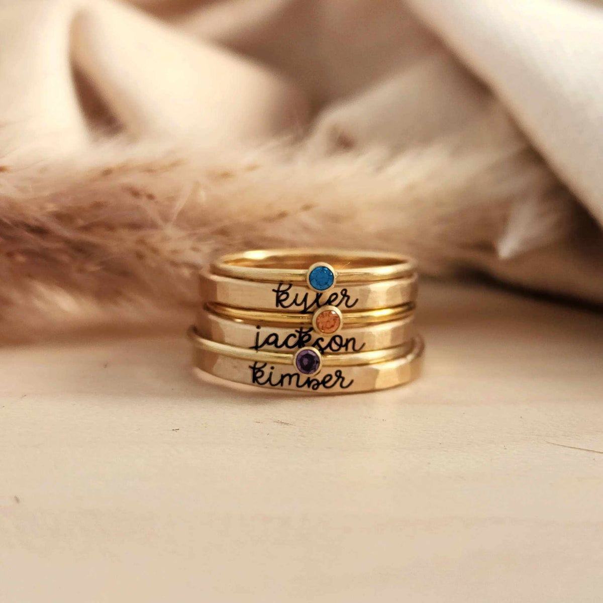 Stacking name ring set with personalized cursive name rings and coordinating birthstone rings in silver and 14K gold-filled metals