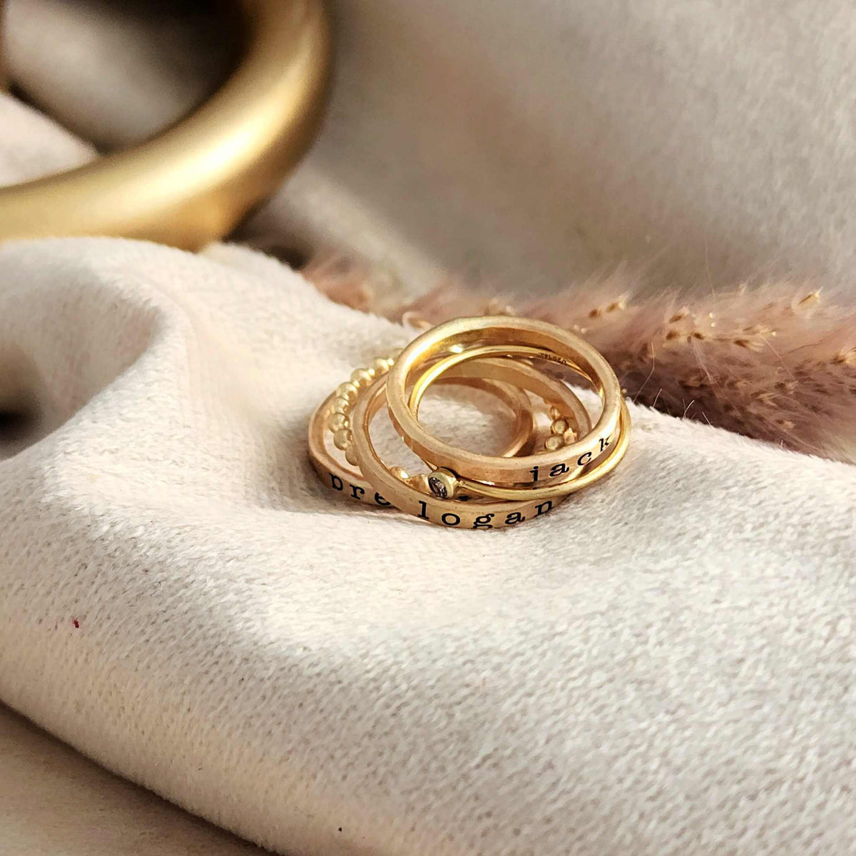 three personalized name rings engraved in our typewriter font, one beaded ring, one birthstone ring