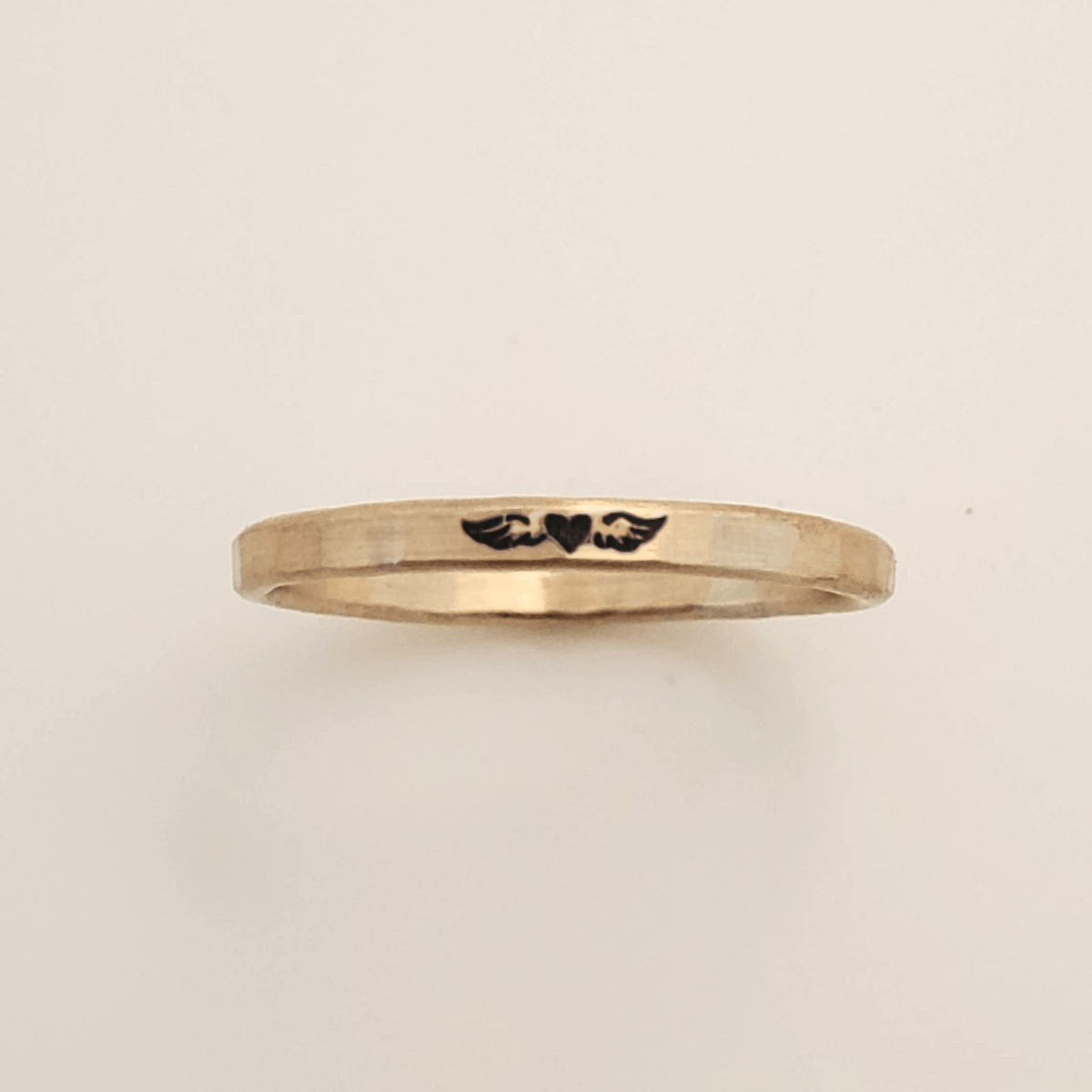 Memorial angel wing ring in silver with hand-engraved delicate design on slim band
