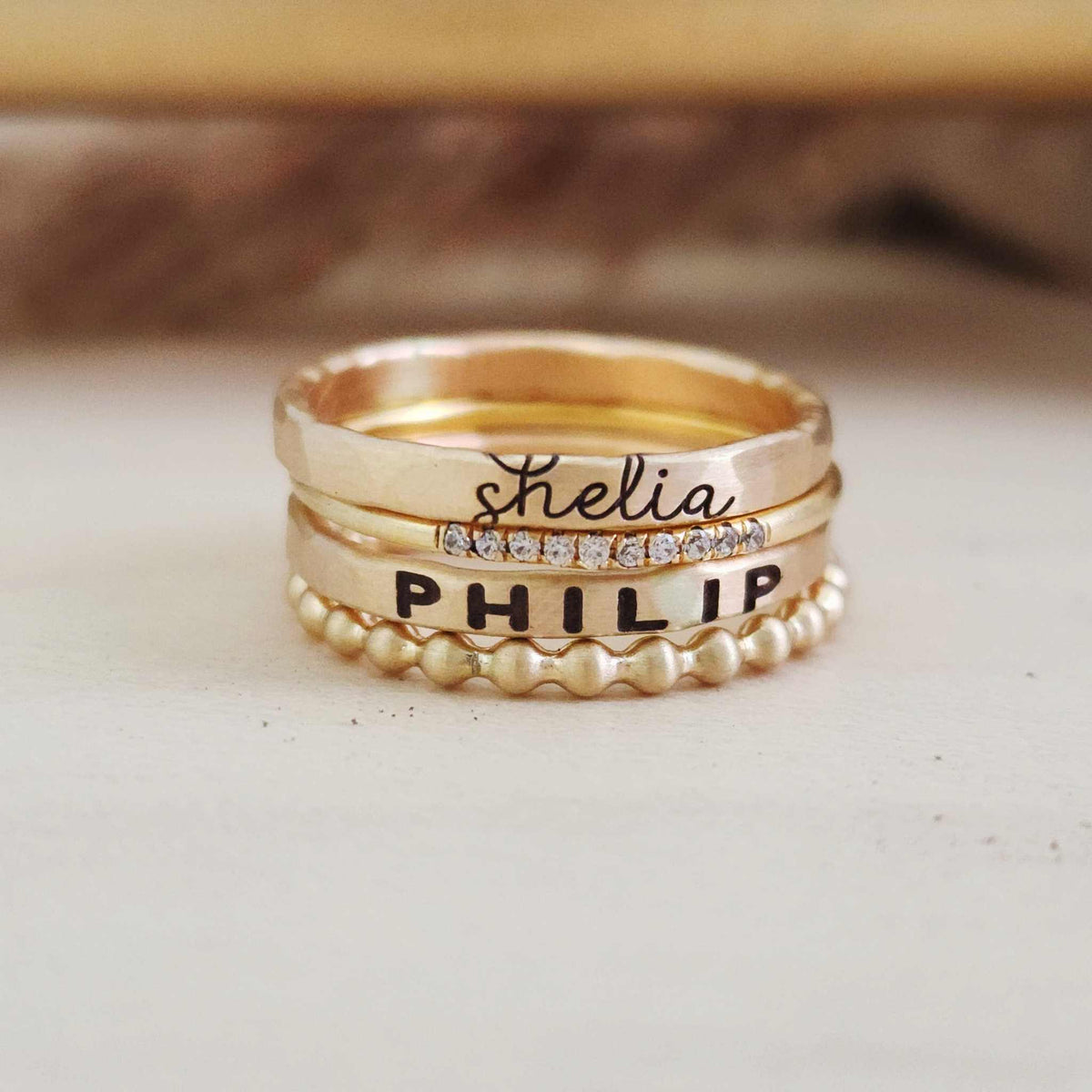 Layla Stacking Name Ring Set featuring personalized 14K yellow gold name rings, cubic zirconia, and beaded design for elegant layering