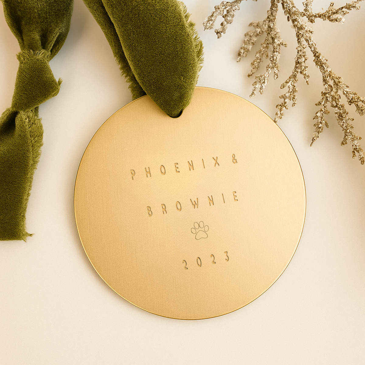Personalized 3-inch brushed brass pet ornament with paw print detail and custom text, gold Christmas decoration for pets