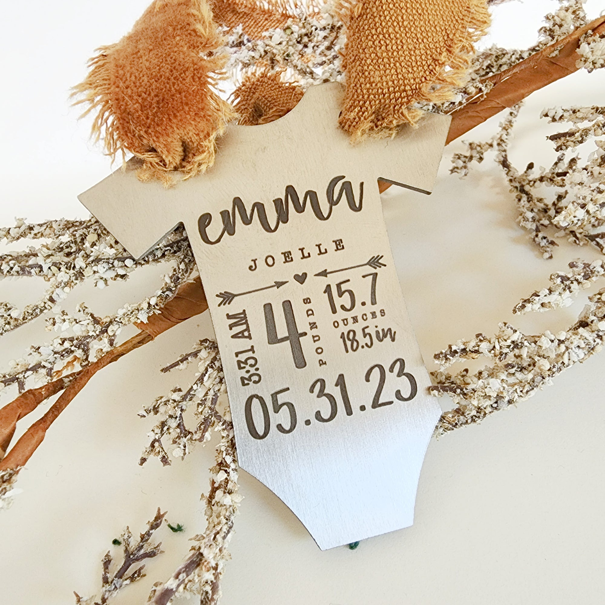 Personalized baby stats ornament with engraved name and birth details on wood