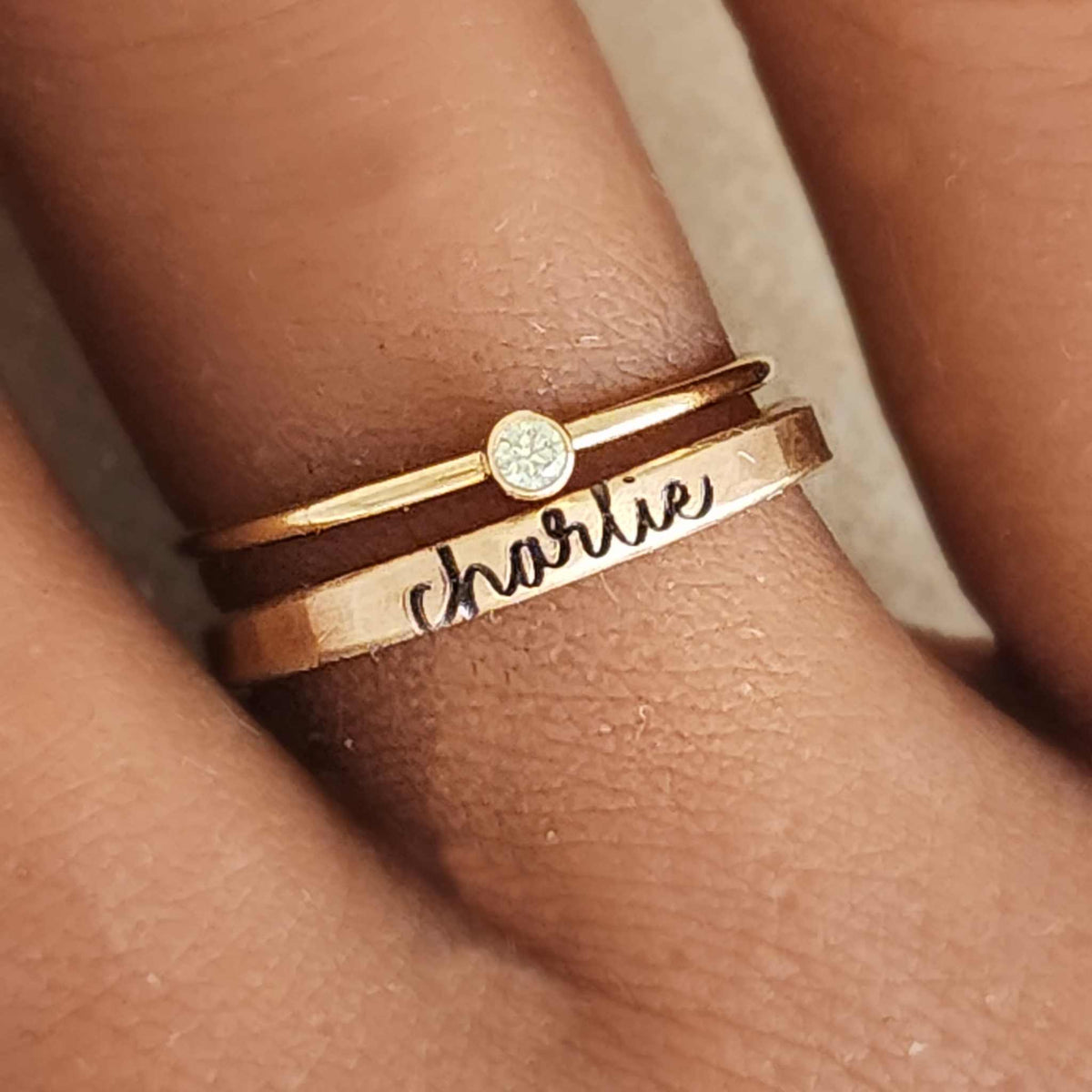 The Clara Stacking Ring Set featuring personalized custom name rings in gold and silver with birthstone accents