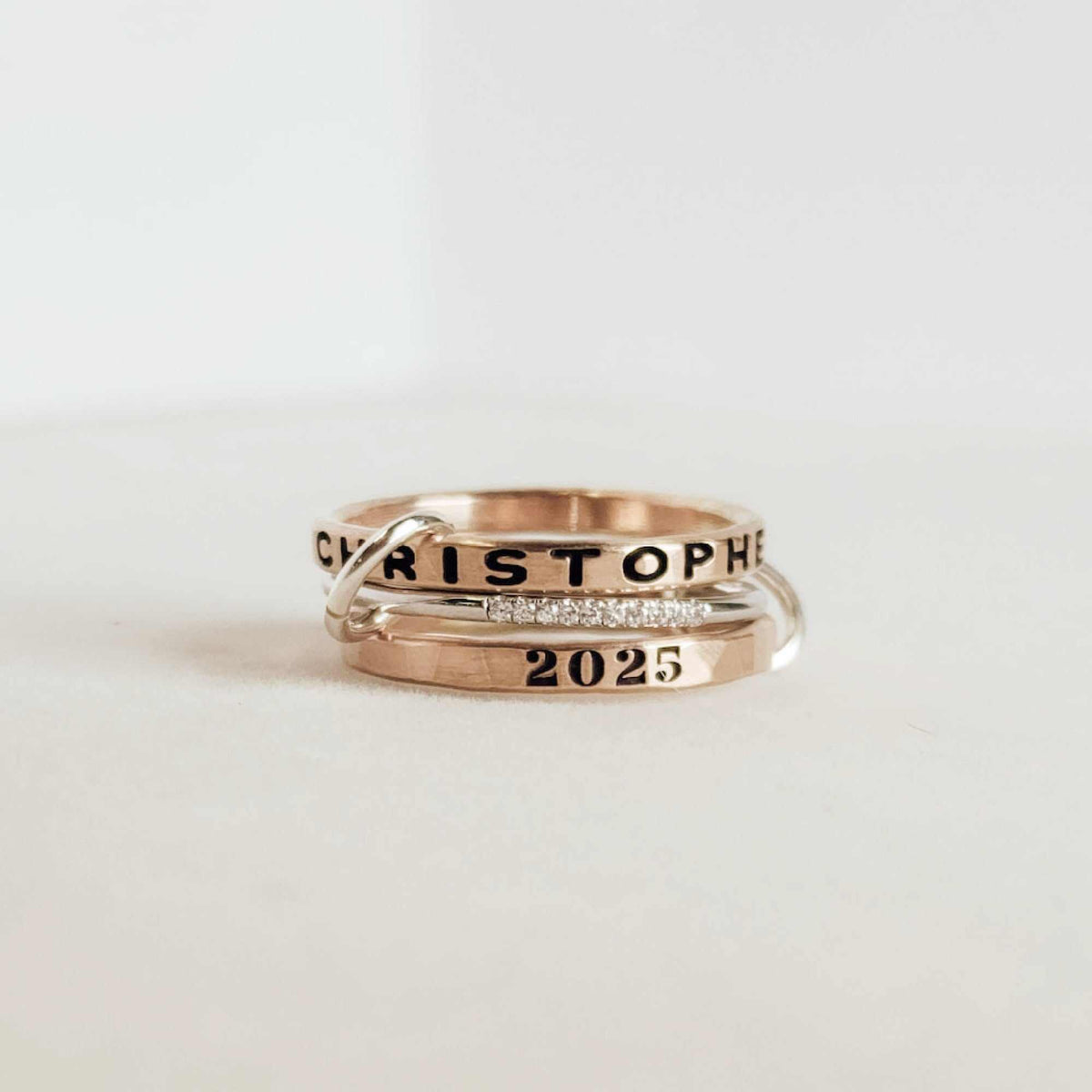 Milestone Mixed Metal Connected Rings set with gold-filled name and year rings, sterling silver CZ ring linked by jump rings