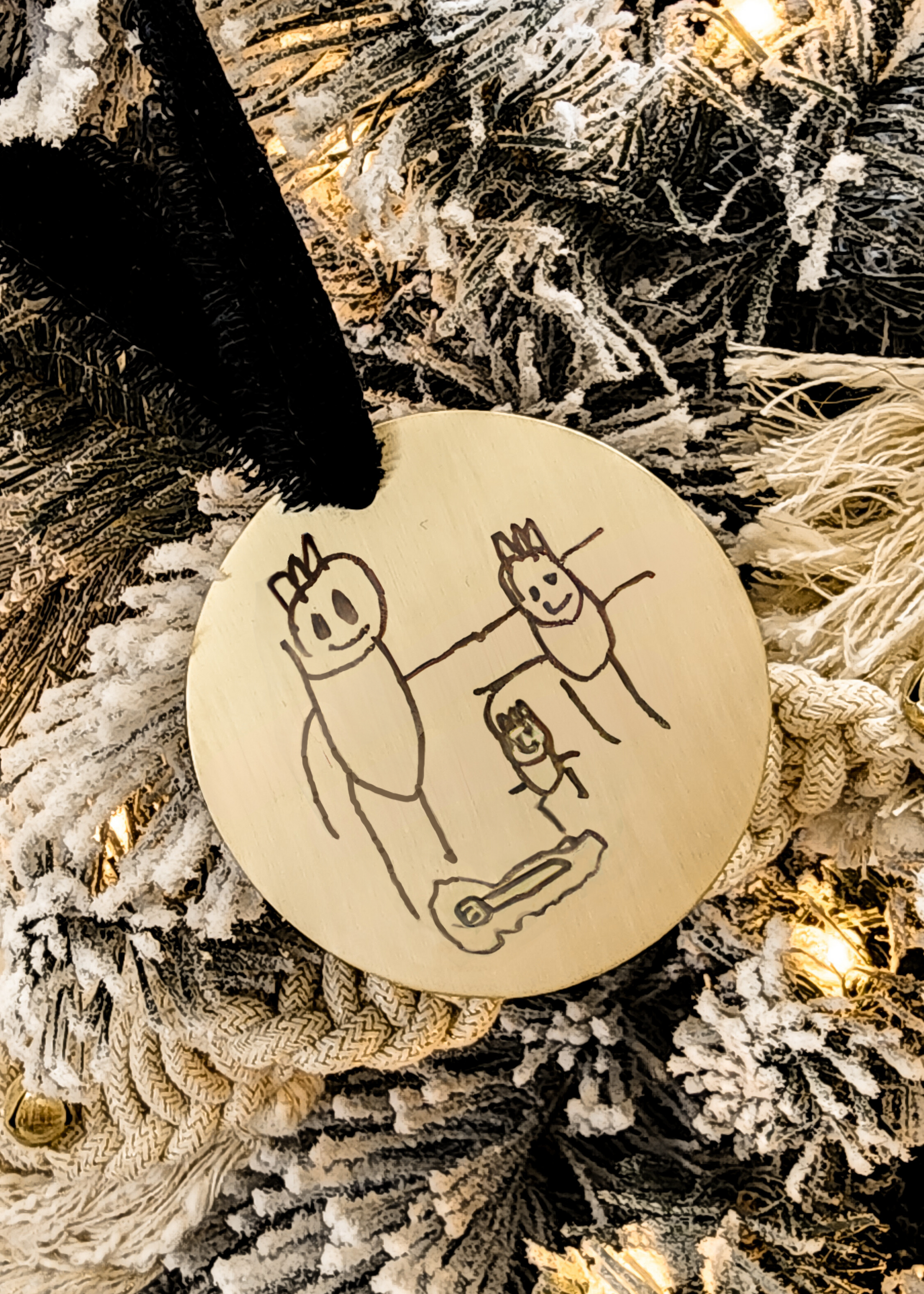 Custom child drawing ornament engraved with stick figure family on gold round base with velvet ribbon