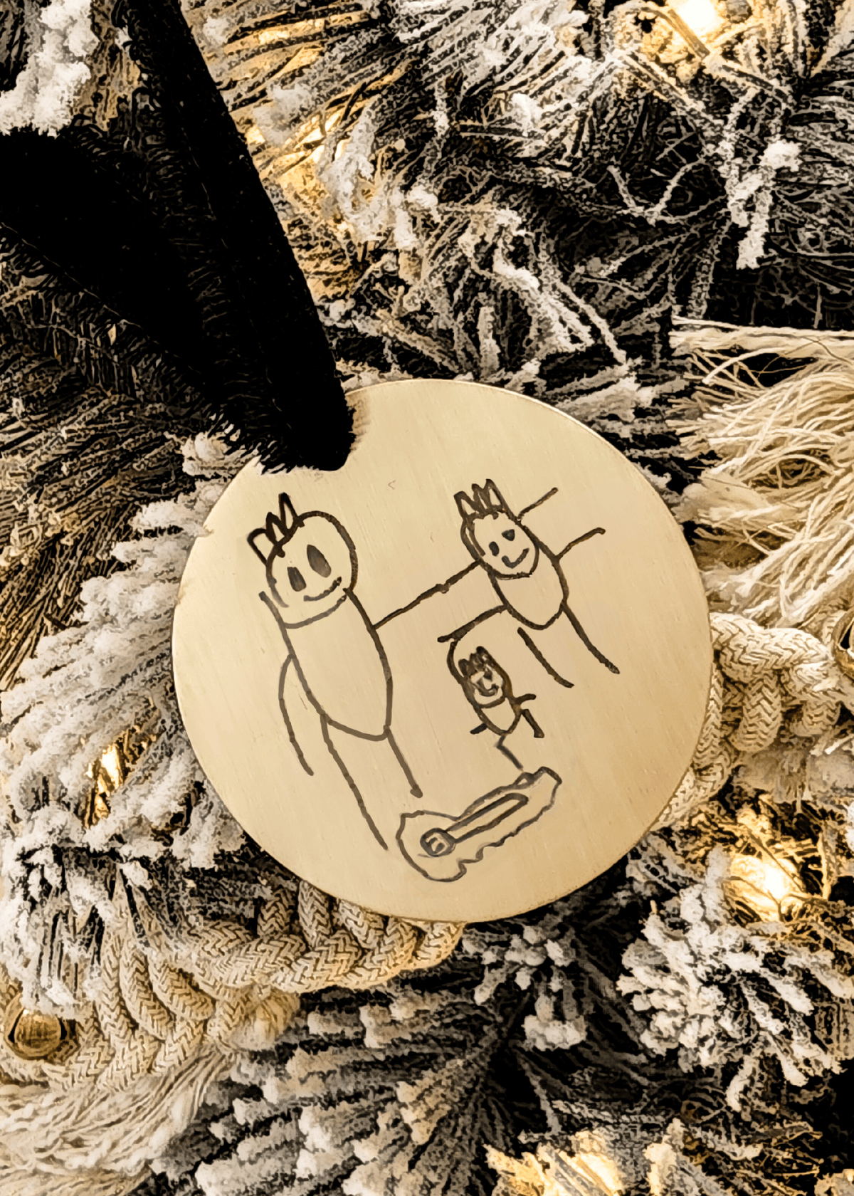 Custom child drawing engraved on round brass ornament with velvet ribbon hanging