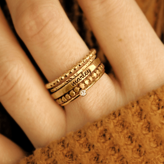 five gold rings on a hand