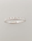 A silver stacking name ring with the name 'brody' hand-stamped on it.