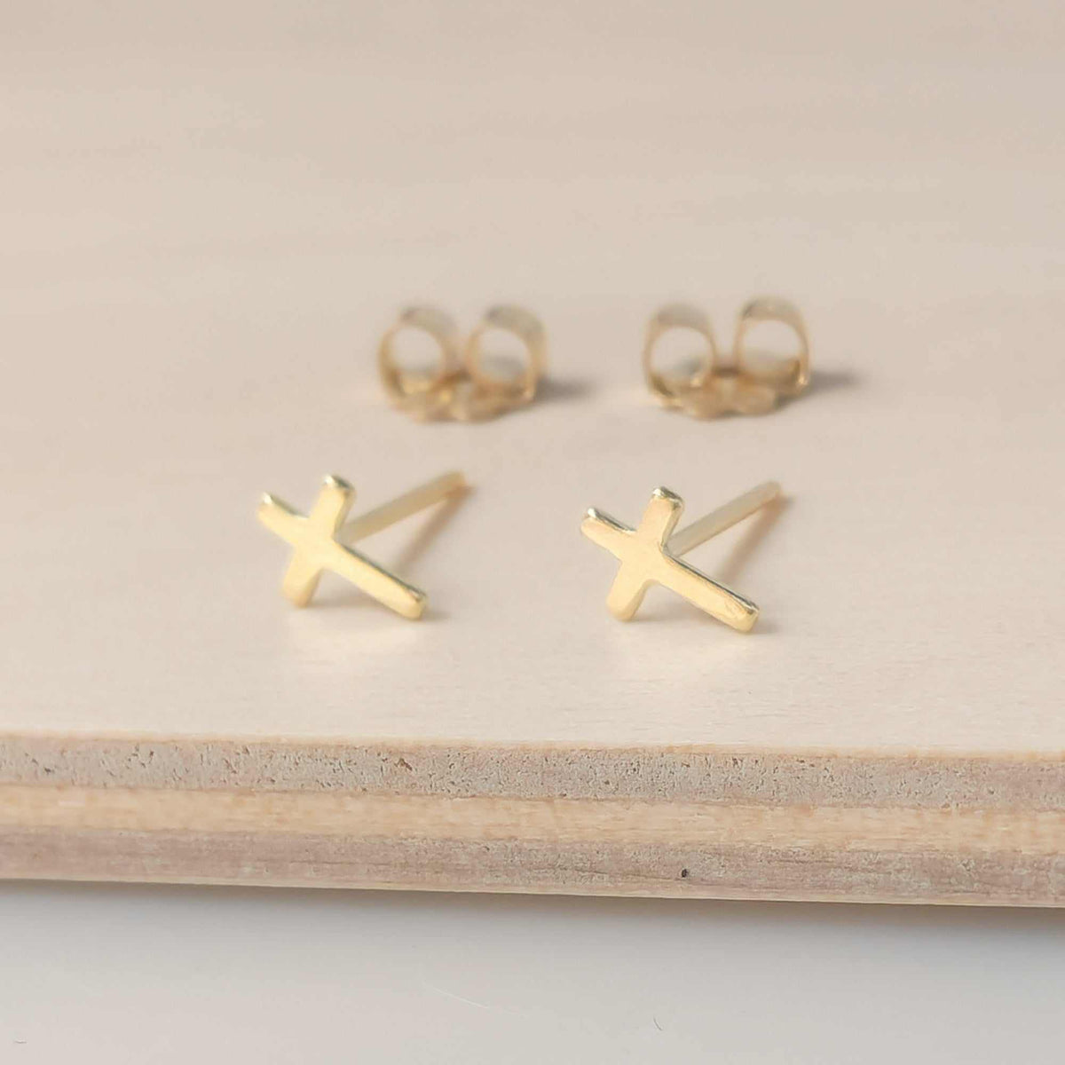 Dainty cross stud earring in 14K gold-filled metal with polishing pad and gift box