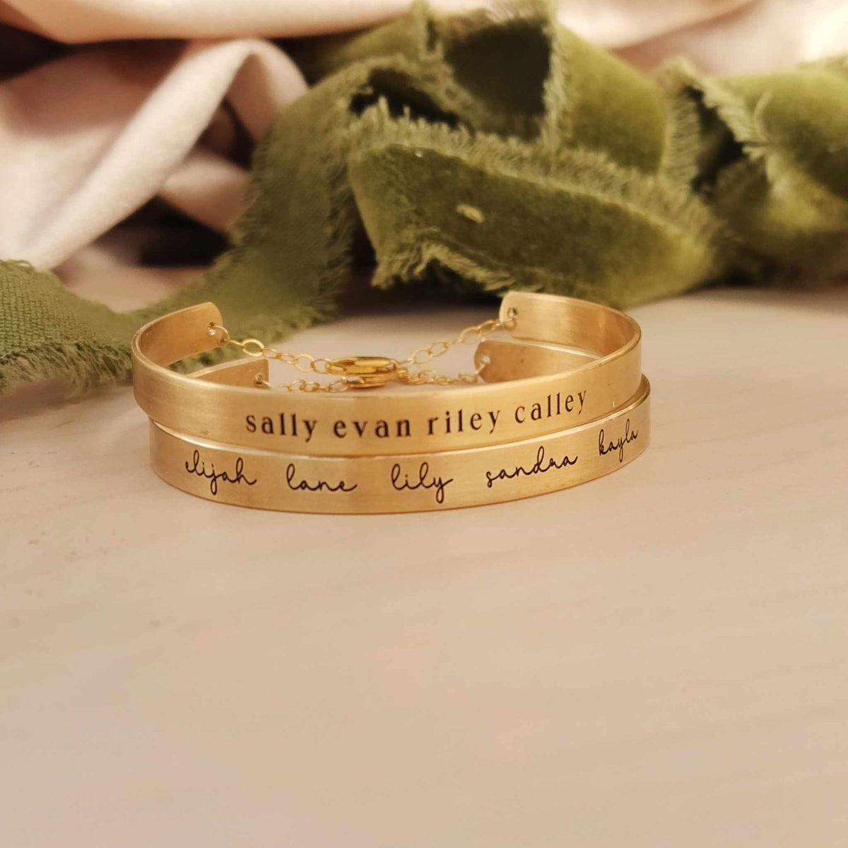 Elegant custom name cuff bracelet personalized with engraved names, dates, or words in brass or sterling silver.