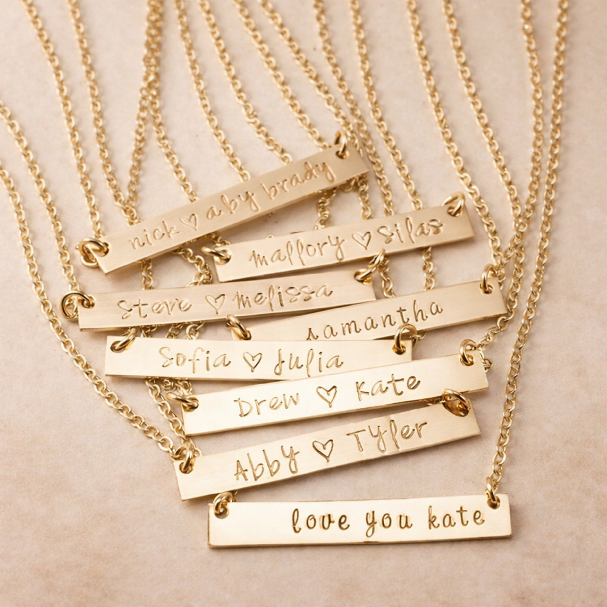 Elegant gold bar stamped name necklace with brushed finish and customizable characters on an adjustable chain