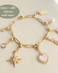 A gold charm bracelet with interchangeable charms including a star and a heart, displayed on a neutral background.