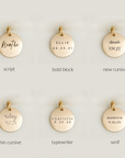 Gold pendants with different text styles on a light gray background