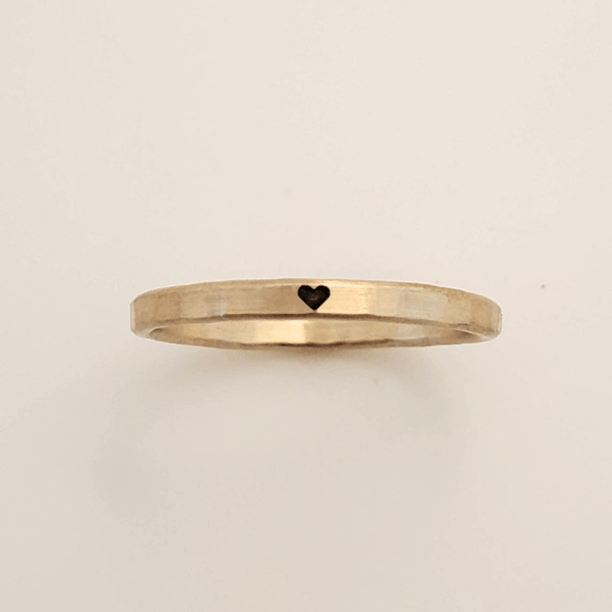 Delicate handmade skinny heart ring in yellow gold with unique solder spot and polished finish