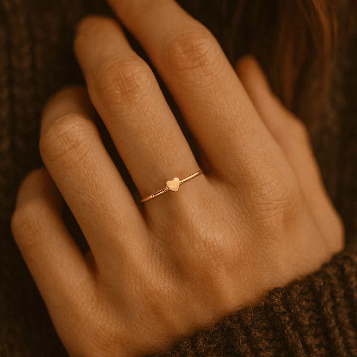 Delicate small heart ring with minimal heart design on slim band in polished finish