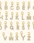 Gold letter pendants with diamonds on a white background