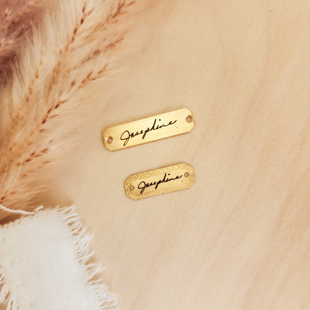 Close-up of a gold Handwriting Bracelet Tag engraved with a loved one’s handwritten signature, featuring a smooth finish and delicate lettering