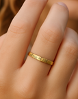 Gold ring with 'Class of 2018' engraving on a person's finger