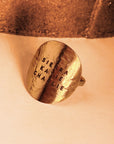 Detailed close-up of hand-stamped 14K gold filled disc ring showing hammered texture