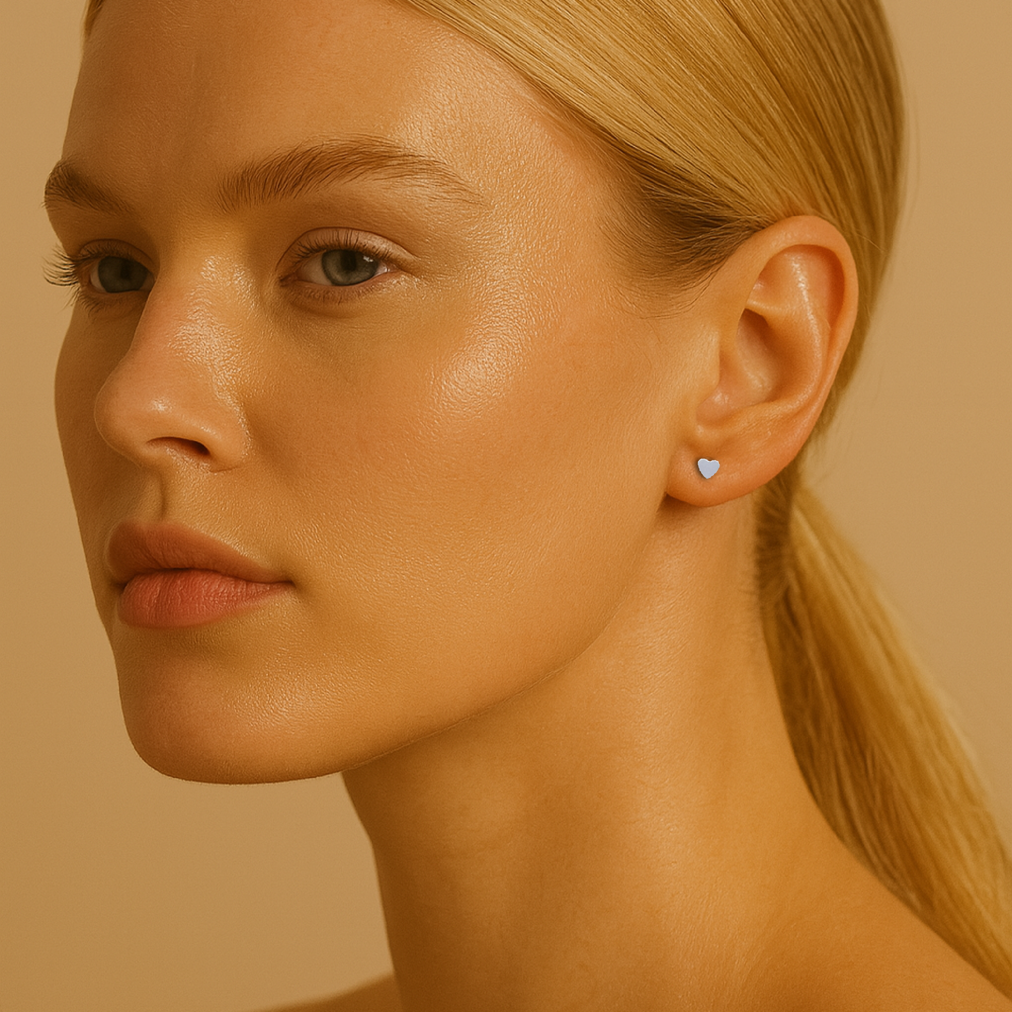 Close-up of a woman wearing a heart-shaped earring against a beige background