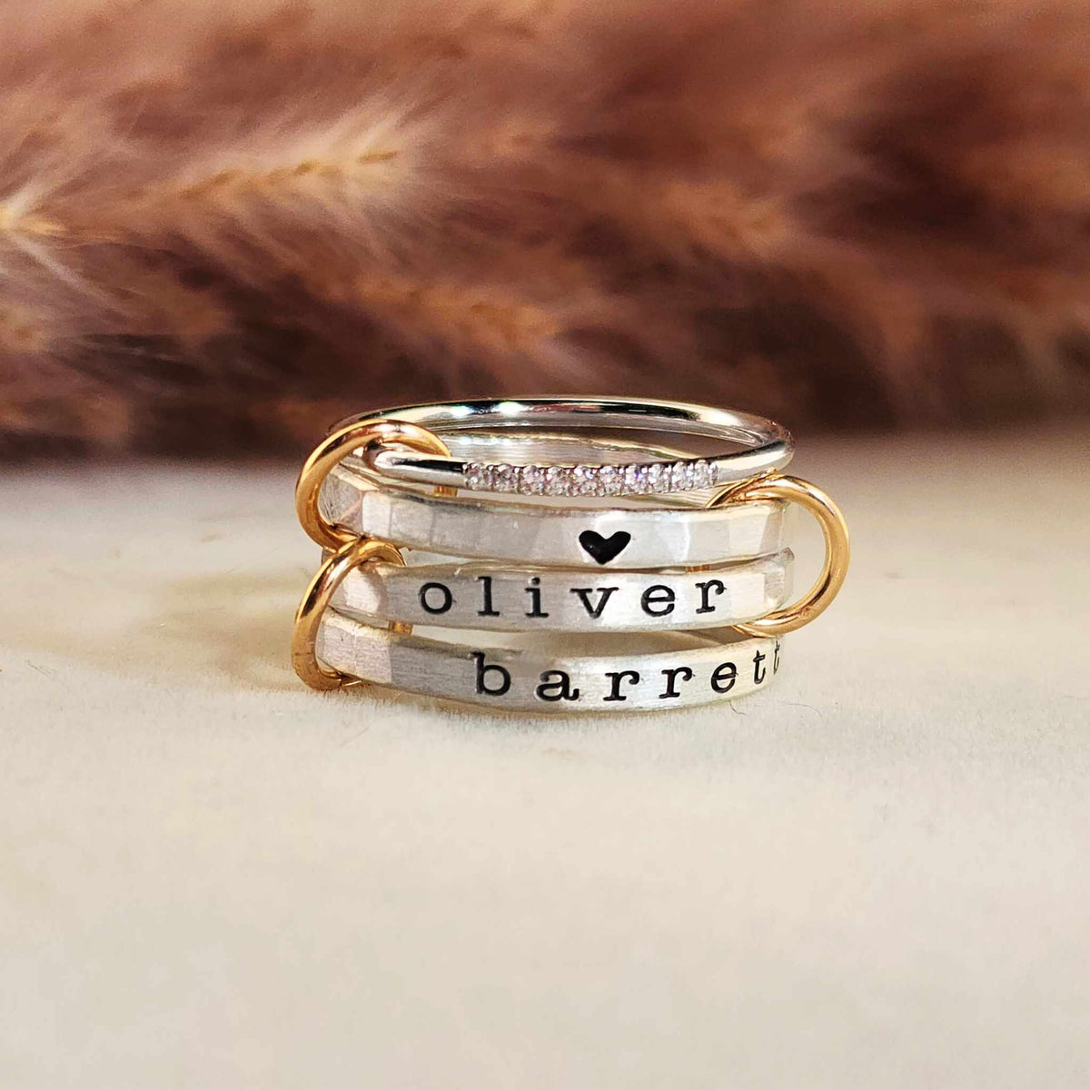 Connected personalized silver ring set with three name rings and gold-filled link connectors