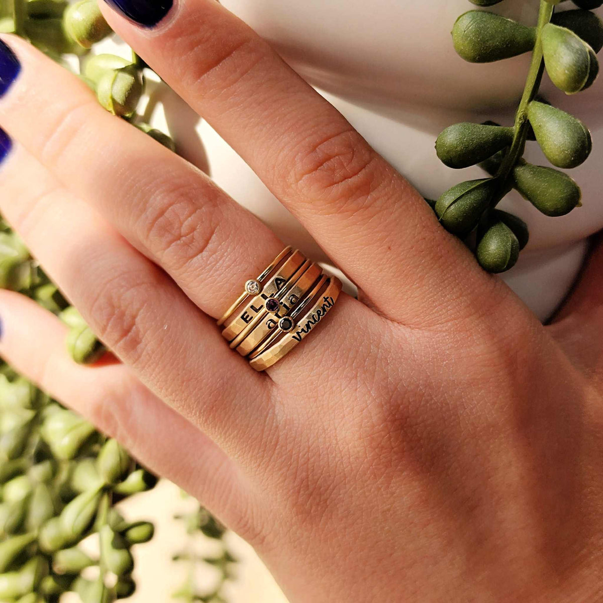 three birthstone rings and three personalized rings with a mix of fonts for a playful stacking ring design
