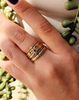 three birthstone rings and three personalized rings with a mix of fonts for a playful stacking ring design