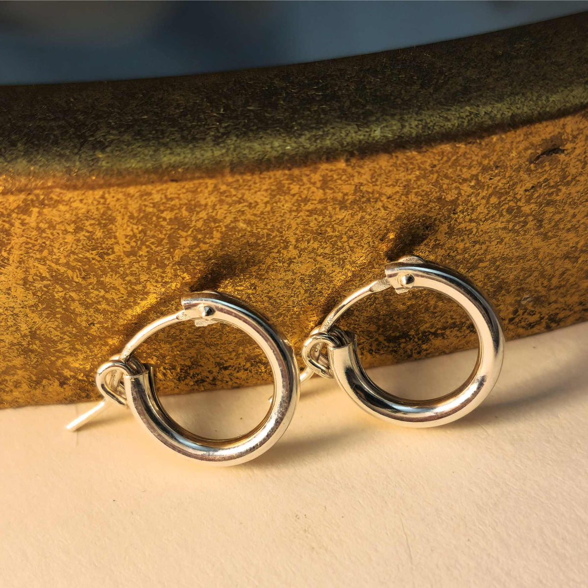 Three sizes of lightweight everyday gold and silver hoop earrings with 2mm thick wire
