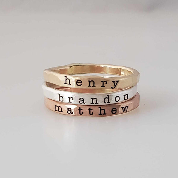 Custom name ring set with three handcrafted stacking rings in yellow gold, sterling silver, and rose gold, personalized for mom's everyday wear.