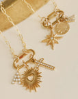 Gold necklace with various charms on a beige background