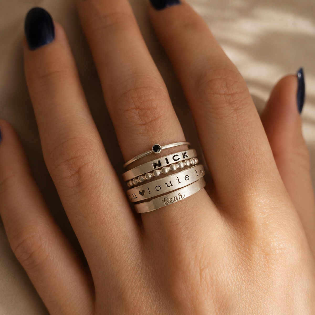 The Arianna Set of unique birthstone, name, and spacer rings in mixed fine and sterling silver and gold-filled metals