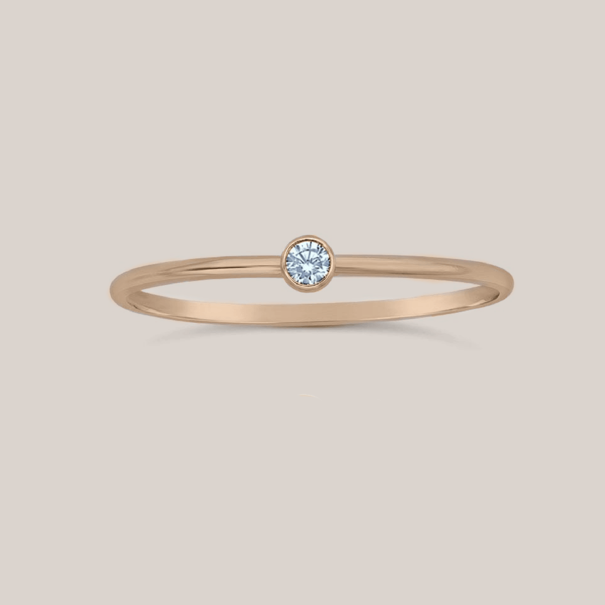 March birthstone ring with 2mm aquamarine crystal on a 1mm slim band in rose gold, yellow gold, and sterling silver