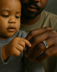 Child holding a hand with a ring, close-up shot