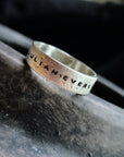 Silver ring with 'JULIAN.EVERLY' engraving on a dark surface