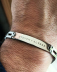Silver bracelet with engraved names on a wrist