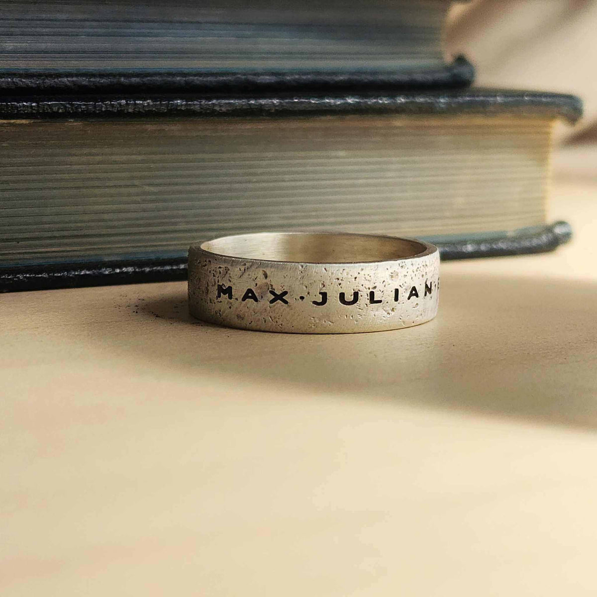 Mens sterling silver name ring with rugged sandcast texture and oxidized finish