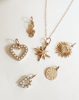 18k gold plated PVD add-on charms displayed with Going Golden gift boxes and packaging