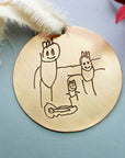 Engraved gold ornament with custom child drawing, cream ribbon and red accents